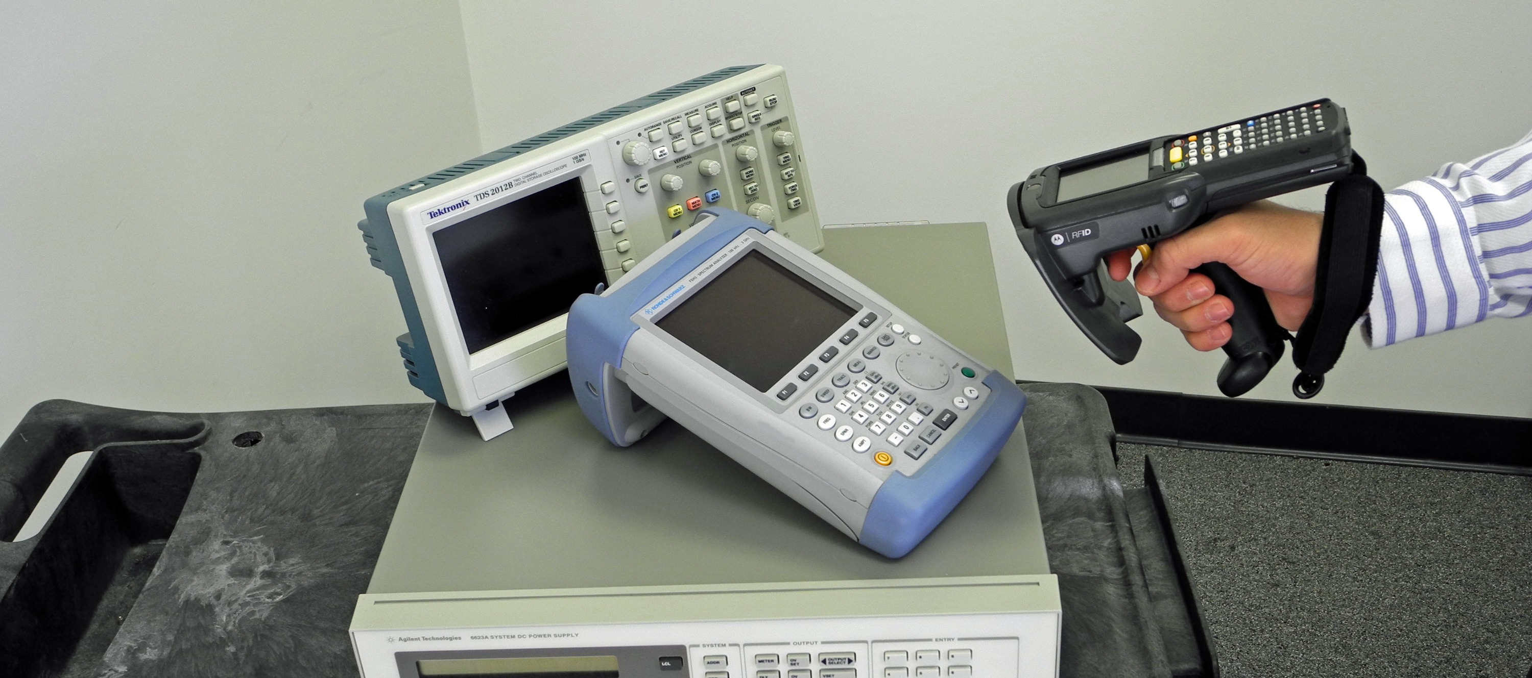 Handheld RFID reader scanning tagged electronic equipment